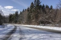 a road with no cars and some snow on the sides of it that is a large amount of snow