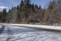 a road with no cars and some snow on the sides of it that is a large amount of snow