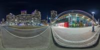 a fisheye lens with an intersection in the foreground and buildings on the far side