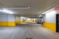 empty parking garage with lots of yellow walls in the building's interior area and doors open