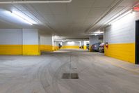 empty parking garage with lots of yellow walls in the building's interior area and doors open