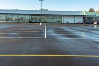 a empty parking lot in a big, empty parking lot with only one car and two people walking in the lot