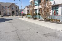 a street scene with focus on the fire hydrant and apartment complexes on either side of the road