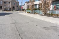 a street scene with focus on the fire hydrant and apartment complexes on either side of the road