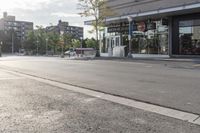 city street corner with cars, building and a sidewalk in the background of a sunny day