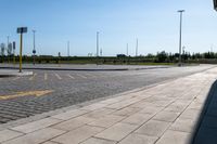 a city street with no cars on a sunny day, a street is empty but the asphalt on both sides has a yellow line drawn