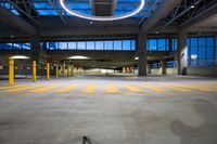 an empty parking space with yellow lines running between columns and a circular light fixture overhead