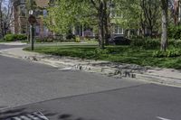 a row of houses line a city street and sidewalk with bricks placed in the middle of it