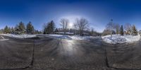 the snow on the ground is clear in this fisheye photo that shows it as the same