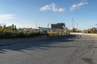 this is an image of a deserted street scene with clouds in the sky and trees