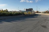 this is an image of a deserted street scene with clouds in the sky and trees