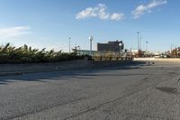 this is an image of a deserted street scene with clouds in the sky and trees