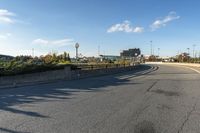 this is an image of a deserted street scene with clouds in the sky and trees