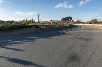 this is an image of a deserted street scene with clouds in the sky and trees