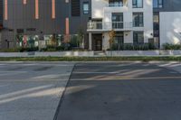 the side of a building that has balks on it and two people standing in the parking lot