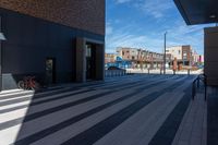 a bicycle is parked outside the building, looking into it from across the street from the sidewalk,