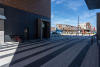 a bicycle is parked outside the building, looking into it from across the street from the sidewalk,