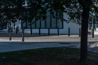 two people are standing on the sidewalk in front of an office building that has windows