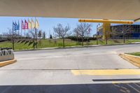 a stop sign is shown in front of an airport walkway with flags on the street