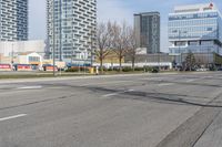 a city street in front of some high rise buildings and an intersection with an empty road