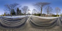 the skate park has tarp covering the street in it's shade as snow covers it