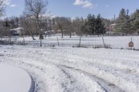 the dirt road has been cleared by a few thick snow tires in this snowy field