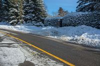 the snow covered road has been cleared off from its contents in some places, making for a nice winter day