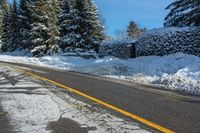 the snow covered road has been cleared off from its contents in some places, making for a nice winter day