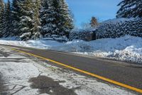 the snow covered road has been cleared off from its contents in some places, making for a nice winter day