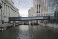 a canal filled with tall buildings in the city of san francisco, california, on a cloudy day