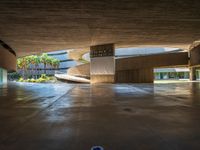 a large concrete building with a parking space and multiple staircases down the middle of it