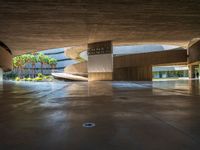 a large concrete building with a parking space and multiple staircases down the middle of it