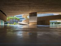 a large concrete building with a parking space and multiple staircases down the middle of it