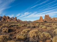 the scenic valley, with rock formations in the background and blue skies above the mountains