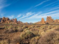 the scenic valley, with rock formations in the background and blue skies above the mountains