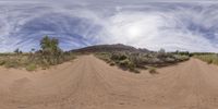 a 360 - view picture taken from a camera lens of a desert road in the distance