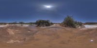 a very big wide angle shot of the road on a dirt field with a full moon in the sky