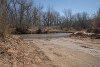 a dirty road that looks very dirty, so people can not cross it as the creek runs into the river