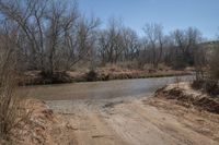 a dirty road that looks very dirty, so people can not cross it as the creek runs into the river