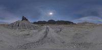 the panorama camera is full view of a big dirt road in front of rock formations