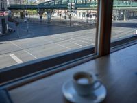 a cappuccino in front of a glass window on a city street outside a train station