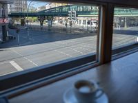 a cappuccino in front of a glass window on a city street outside a train station