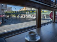 a cappuccino in front of a glass window on a city street outside a train station