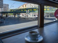 a cappuccino in front of a glass window on a city street outside a train station