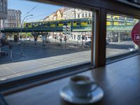 a cappuccino in front of a glass window on a city street outside a train station