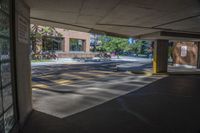 a view of a car park entrance under a bridge on a sunny day's day