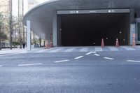 a car is stopped inside the entrance to a tunnel in the city, with many people standing outside