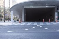 a car is stopped inside the entrance to a tunnel in the city, with many people standing outside