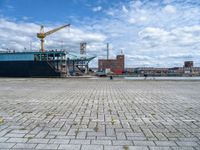 a large cargo ship is on the water's shore and docked in front of buildings