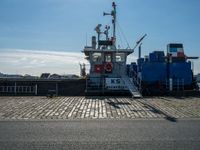 a cargo ship docked at the dock on a sunny day with a blue sky in the background